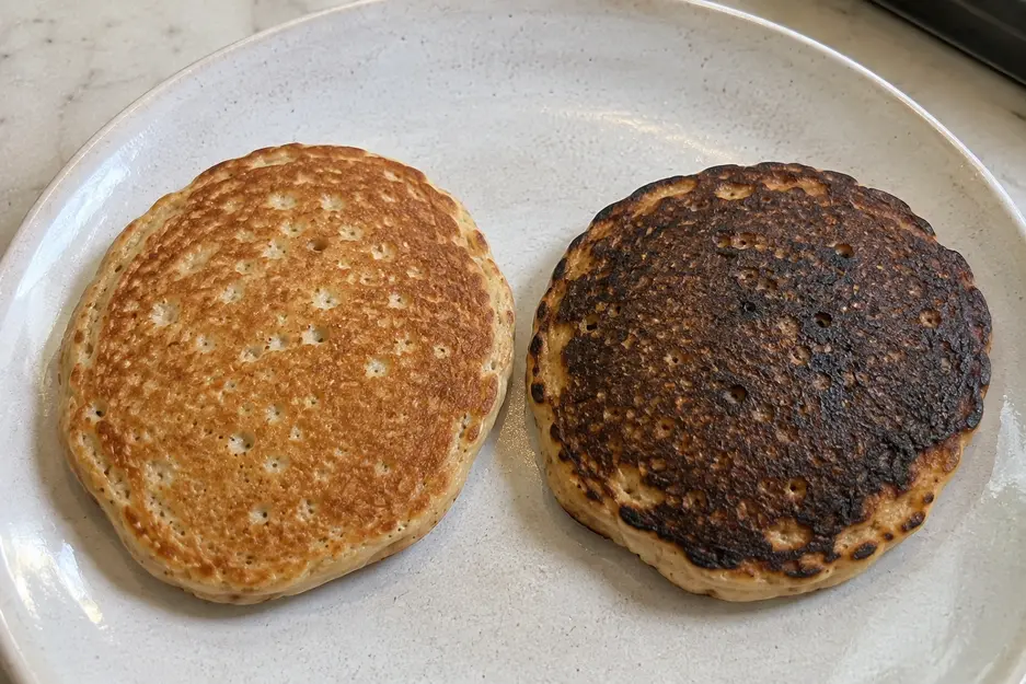 Banana oat pancakes for baby comparison showing one evenly golden, correctly cooked pancake beside an over-browned pancake with natural homemade texture.